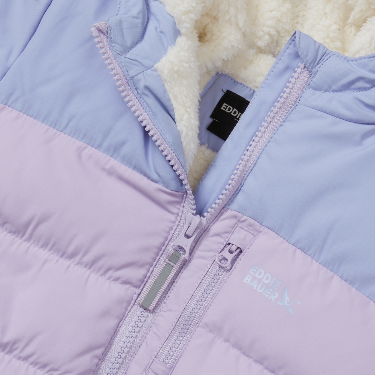 Lavender and pink color-block down jacket with cream fleece lining and front zip closure detail.