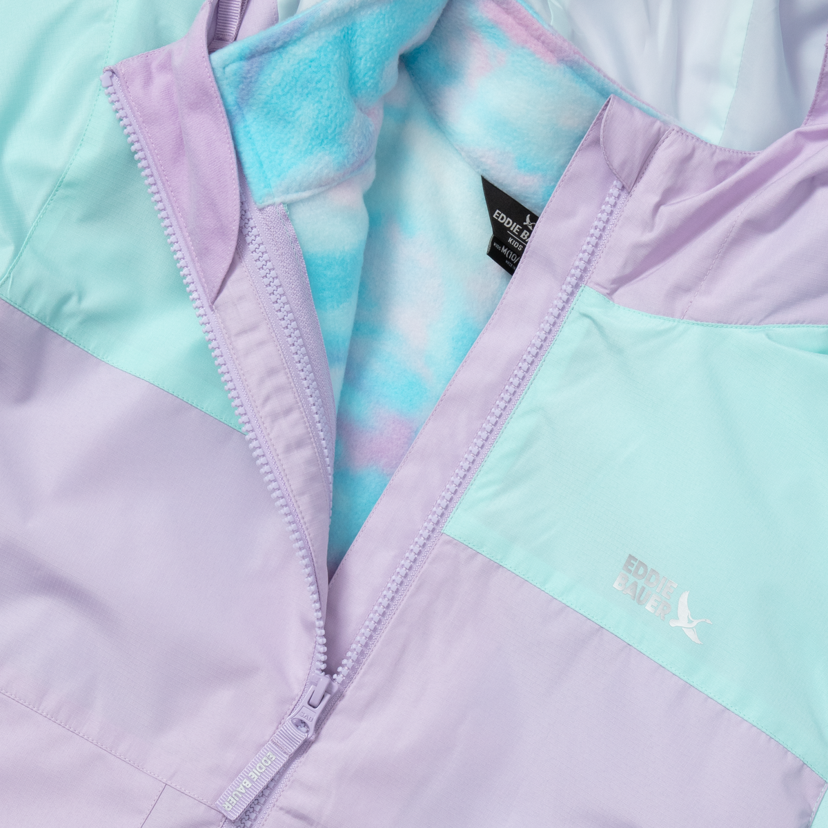 Girls' three-in-one jacket with lavender and mint color-blocked panels, open zipper revealing blue fleece lining.