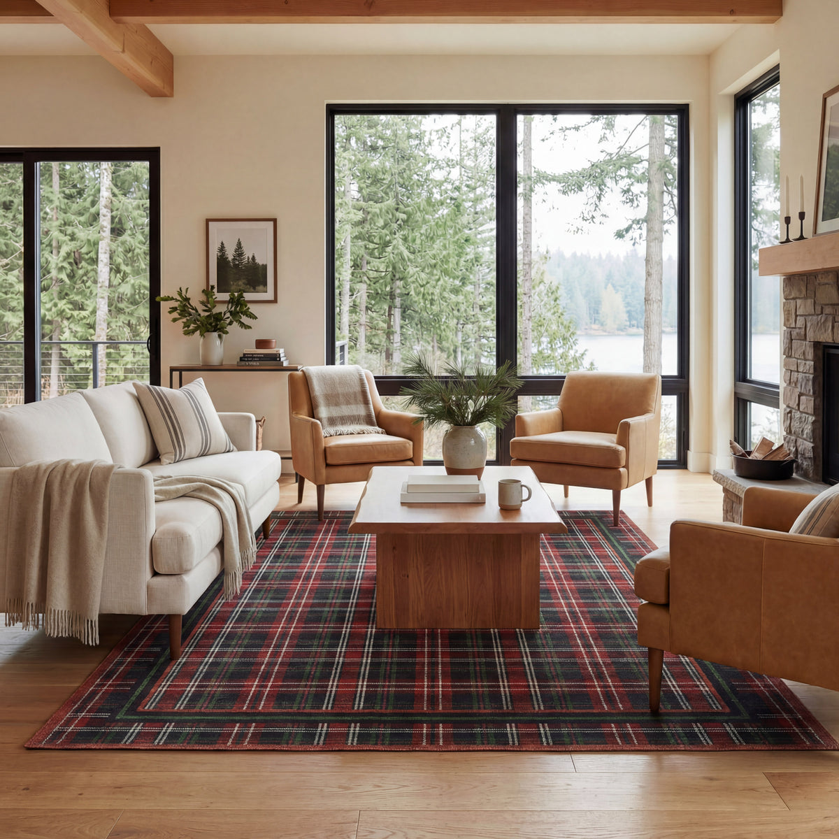 Living room with plaid rug, wooden coffee table, and large windows overlooking trees.