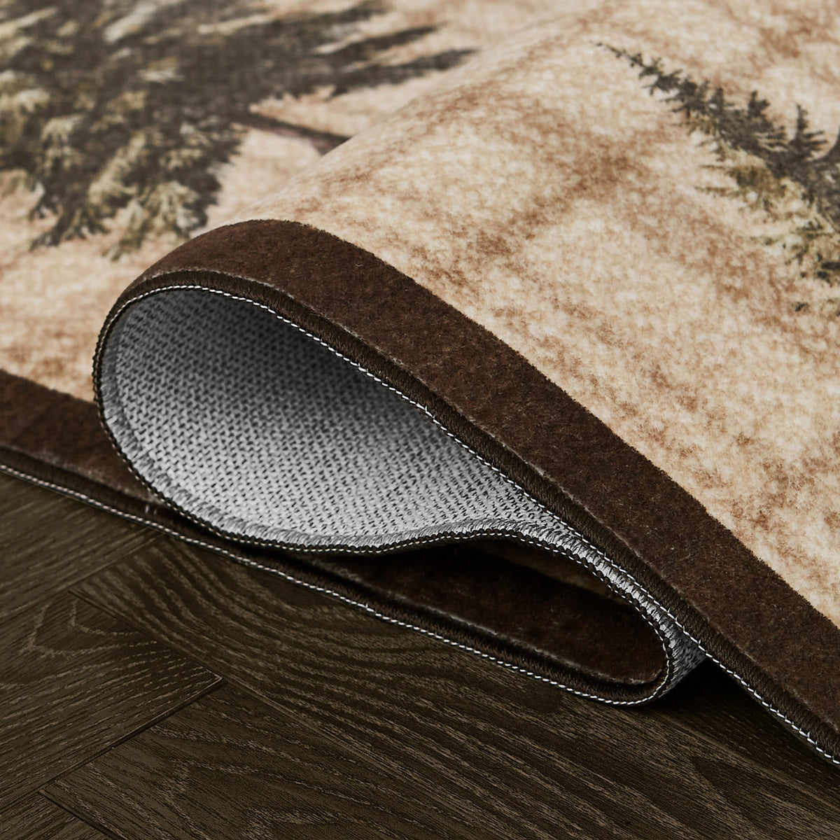 Rolled rug showing cream and brown patterned surface with dark brown binding and gray backing.