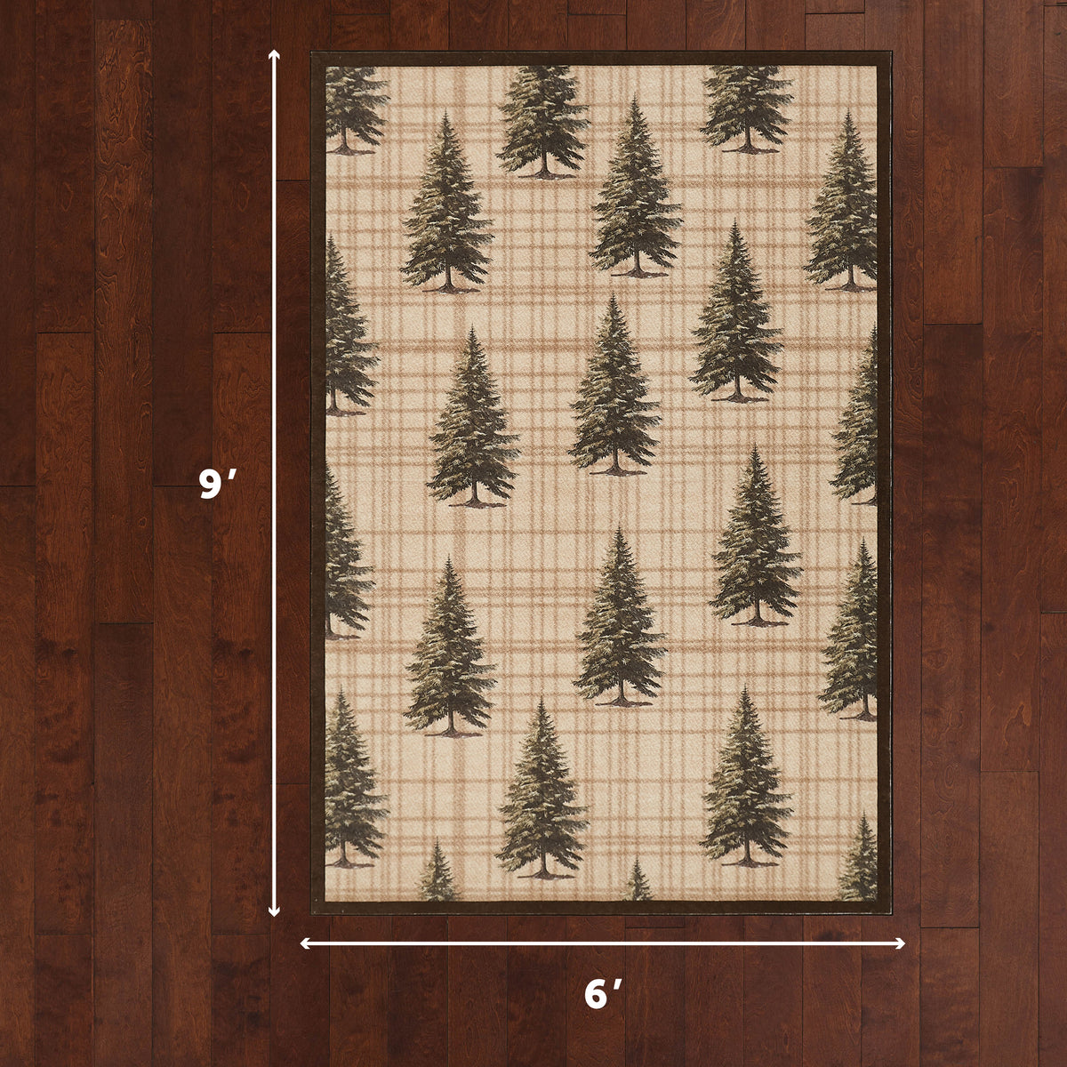 Rectangular rug with tan and cream plaid background featuring scattered evergreen tree pattern, dark border, displayed on woo