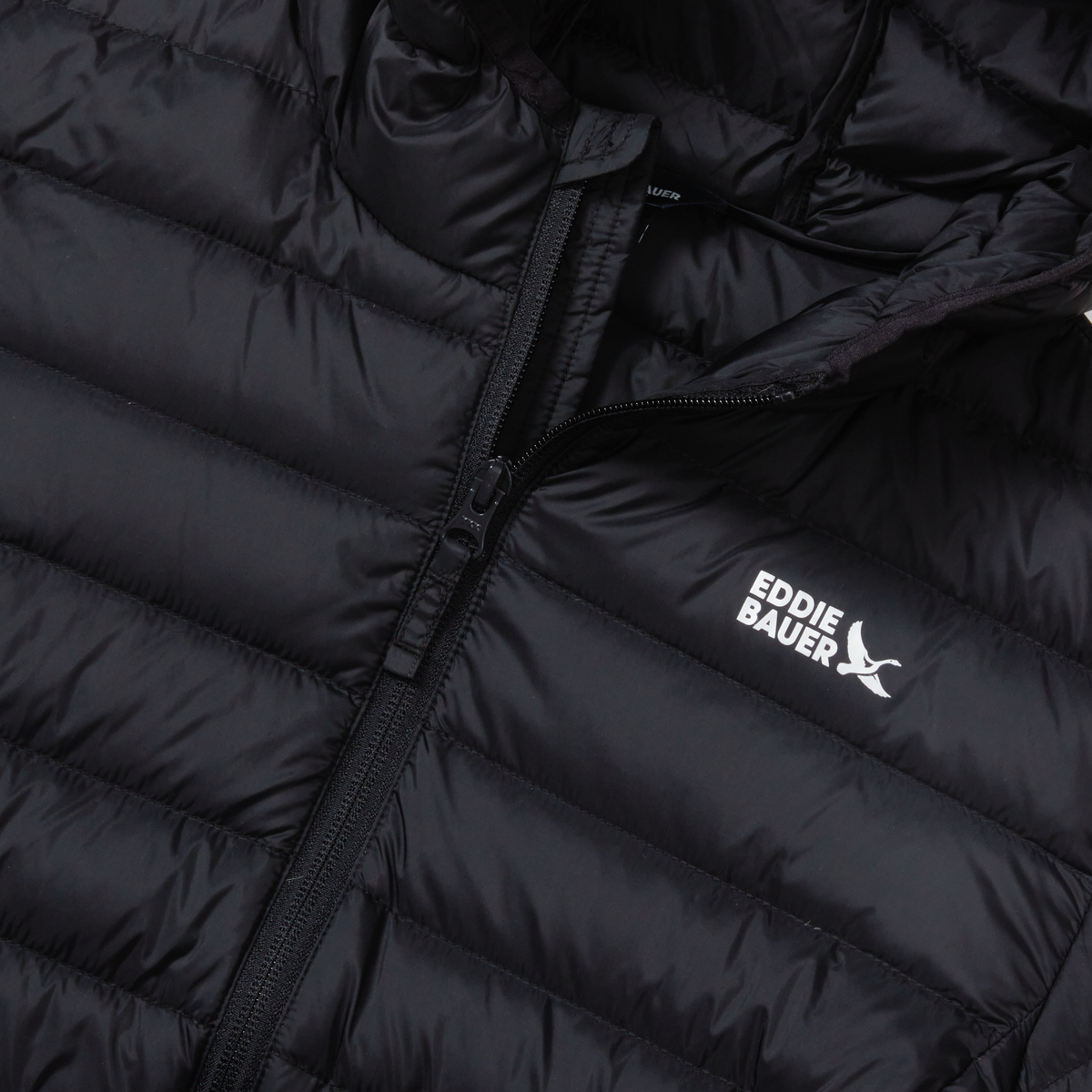 Black quilted down hooded jacket with full-length zipper and Eddie Bauer logo visible on chest.