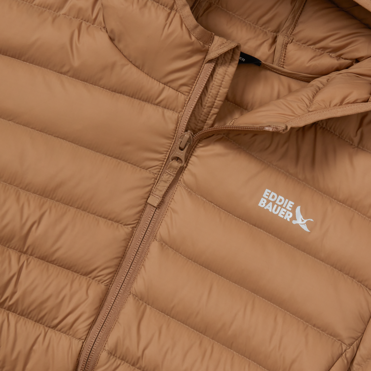 Tan quilted down hooded jacket with front zip closure and Eddie Bauer branding.