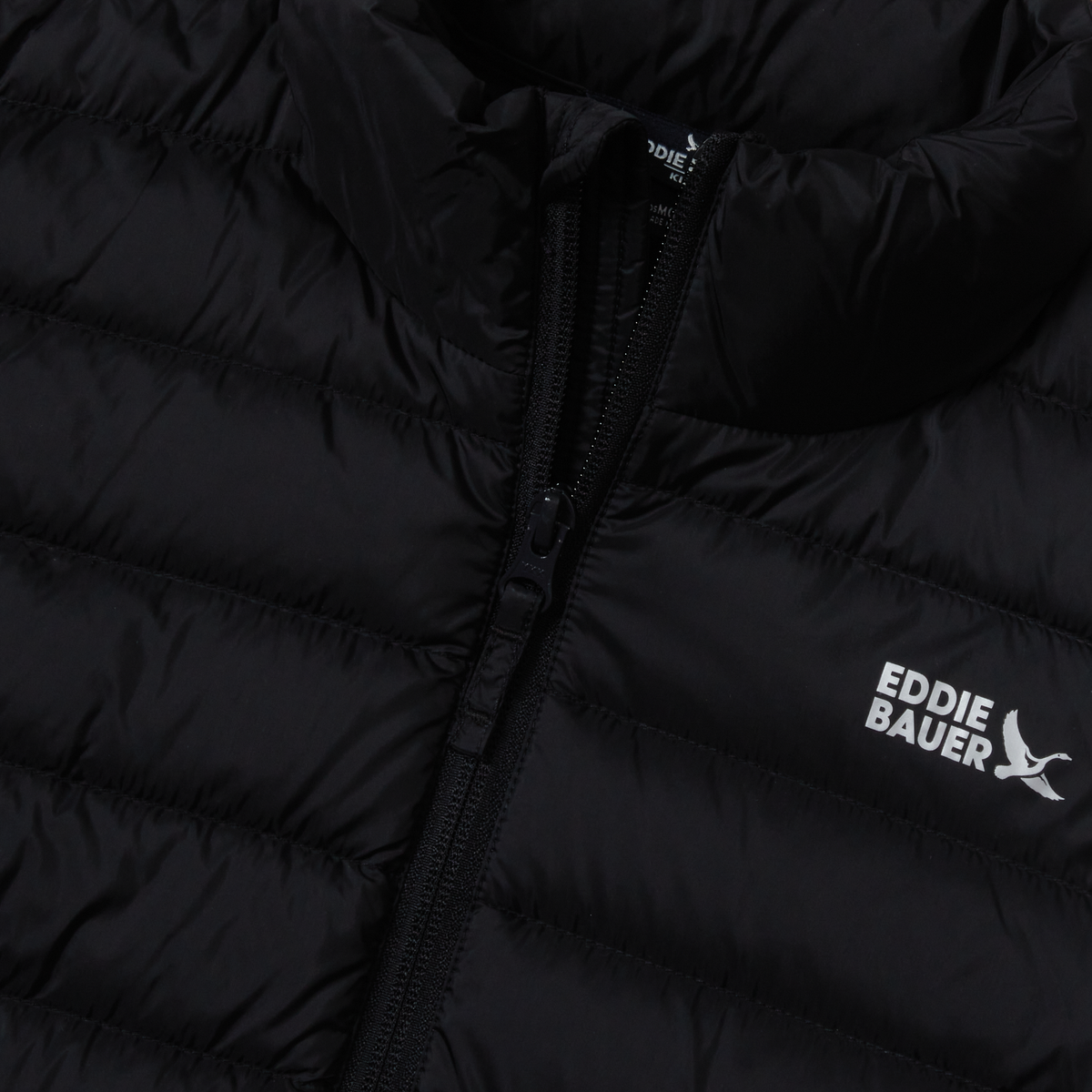 Black quilted down jacket with full-length zip and Eddie Bauer branding on chest.
